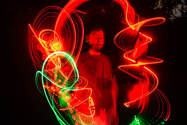 istock Futuristic Portrait of a Man Spinning a Light in Hand 2222945811