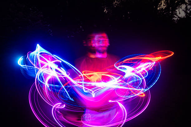 istock Futuristic Portrait of a Man Spinning a Light in Hand 2222945825