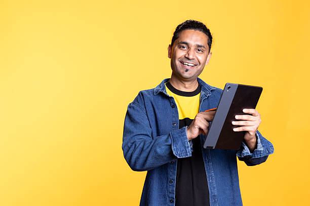 istock Male model smiling and accepting the payment on his mobile device 2222945917