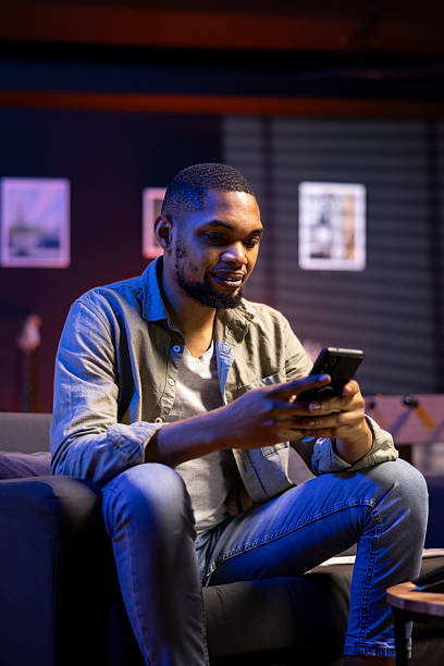 istock Chill self employed guy enjoying a break with his mobile phone on sofa 2222947205