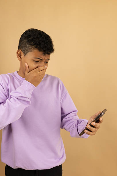 istock Vertical image of a young Latino man with a horrified expression when he sees something on his cell phone 2222947679