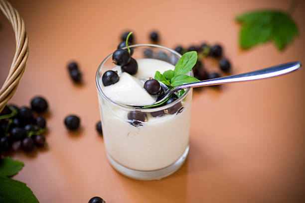 Sour cream in a spoon on white background