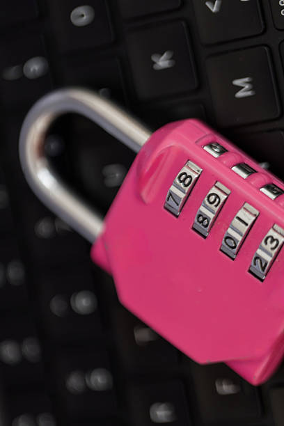istock Concept image of online data safety with combination padlock on keyboard, cyber awareness theme. Pink code padlock placed on laptop keyboard symbolizes cybersecurity and data protection in digital 2222951743