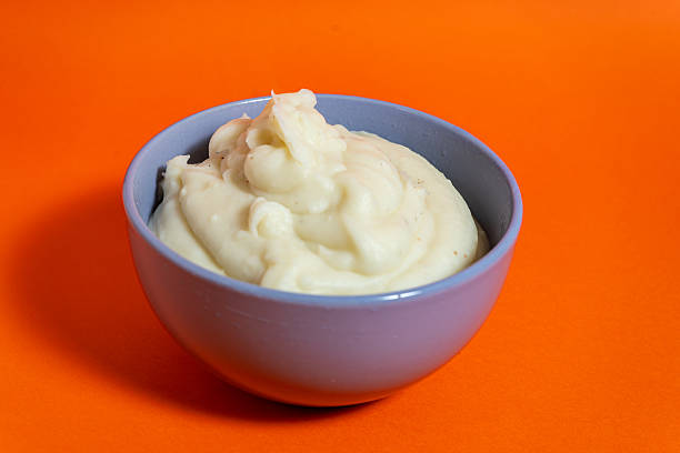 istock Creamy mashed potatoes served in a bowl on orange background 2222952484