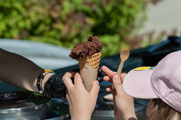 istock Child with a hat under the sun buying an ice cream 2222952641