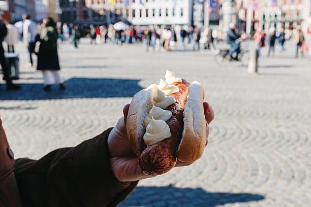 istock A sausage sandwich in a man's hand. 2222952674