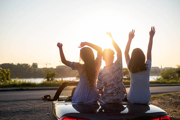 istock teenagers in a convertible having fun 2222954142