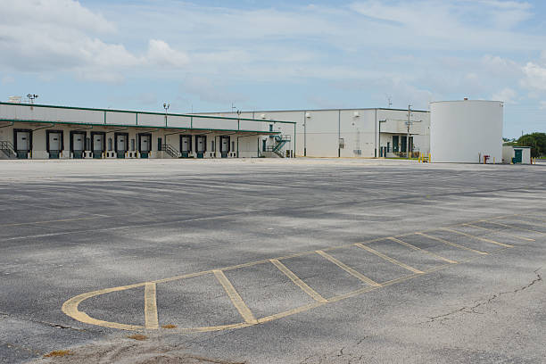 istock Empty Industrial Lot with Warehouse and Storage Facility in the Background 2222954592