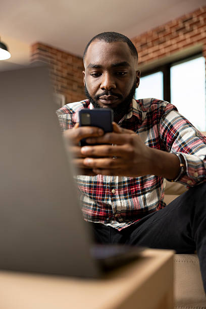 istock Black professional using cellphone to browse social media 2222960624