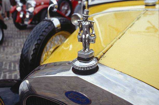 Lisbon, Portugal - Jan 20, 2024: Car design detail of Jaguar chrome wire wheel, stainless steel spokes, polished and chrome-plated with signs of wear-and-tear and bespoke 2-eared wire wheel spinner for splined hub with Jaguar logo. Michelin tyre. English Car Owners club annual meet-up