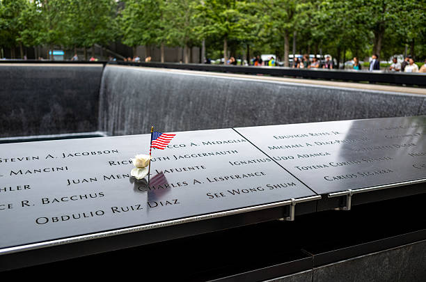 Views of the 9/11 Memorial in the financial district of lower Manhattan, New York at the site of World Trade Center.  This location is considered ground zero.... the site of the former Twin Towers in Lower Manhattan.  The memorial opened on September 11th 2011 and was literally constructed on the footprint of the Twin Towers.  There is also a museum adjacent to the memorial.  The architect, Michale Arad says that the pools of this monument are supposed to represent \