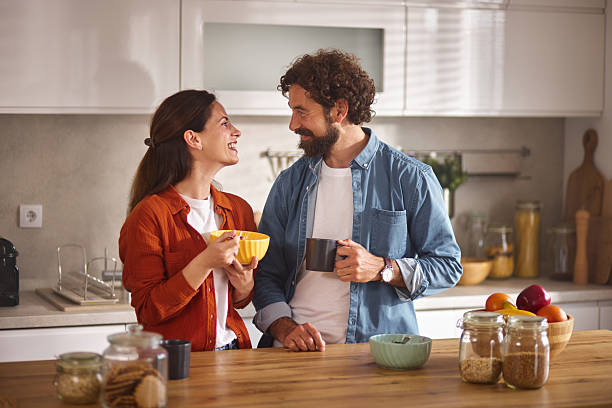 istock Happy couple enjoying breakfast and coffee in kitchen 2222962397
