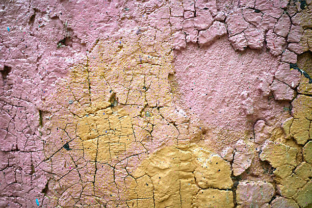 Yellow pink texture background on old cracked concrete wall, full frame