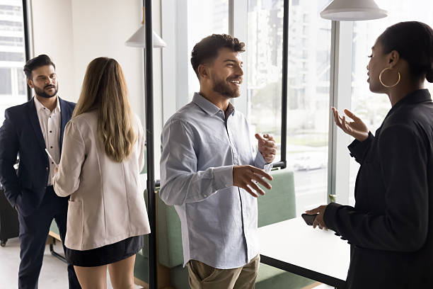 istock Diverse multicultural businesspeople standing in pairs at coworking space talking 2222962759