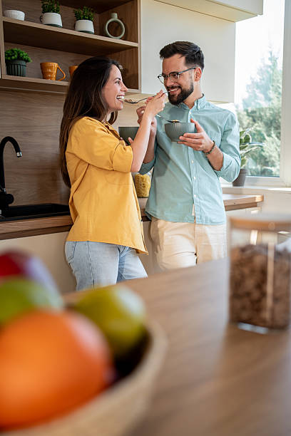 istock Happy couple sharing cereal in modern kitchen during morning breakfast 2222963511