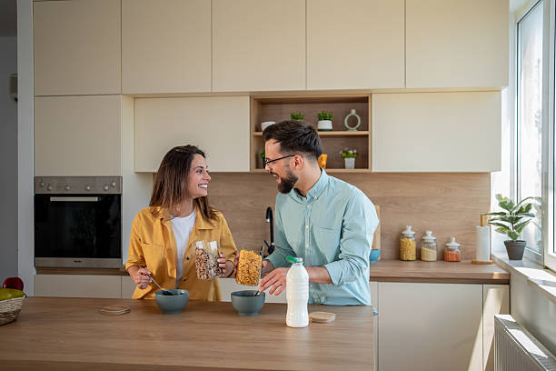 istock Happy couple preparing breakfast together in modern kitchen 2222963635