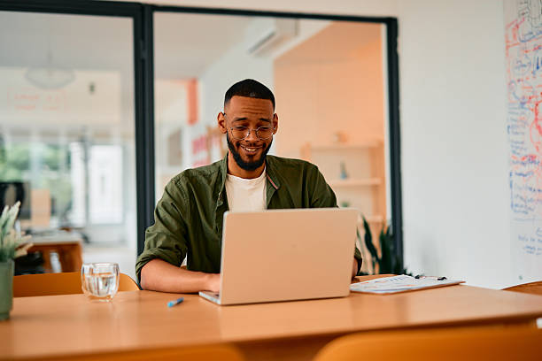 istock Young businessman working on laptop in modern office 2222963782