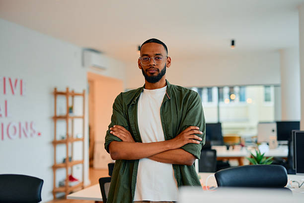 istock Confident young businessman posing with arms crossed in modern office 2222963807