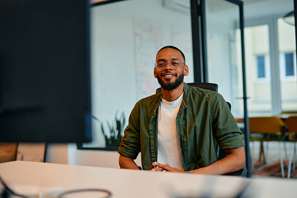 istock Confident young businessman smiling at the camera in the office 2222963821
