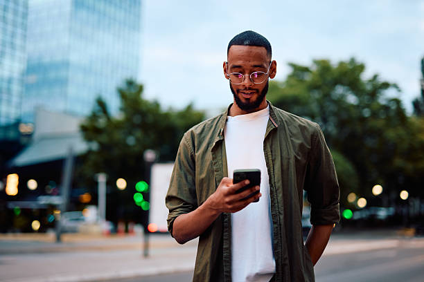 istock Young man using smartphone in urban city at dusk 2222963843