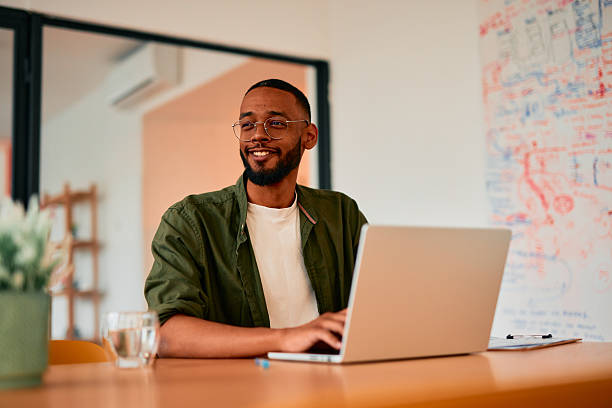 istock Young businessman working on laptop in modern office 2222963851