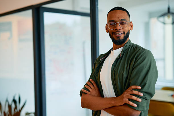 istock Confident young manager smiling with arms crossed in modern office 2222963856