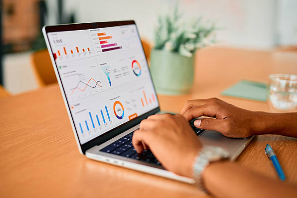 istock Businessman analyzing financial charts and graphs on a laptop 2222963893