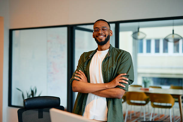 istock Confident young manager smiling with arms crossed in modern office 2222963946