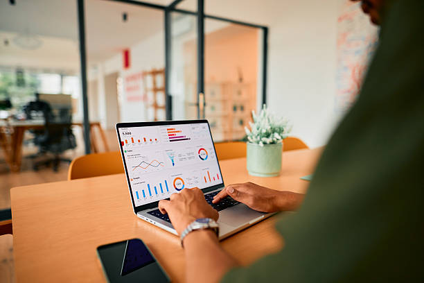 istock Businessman analyzing financial data on laptop in modern office 2222963971