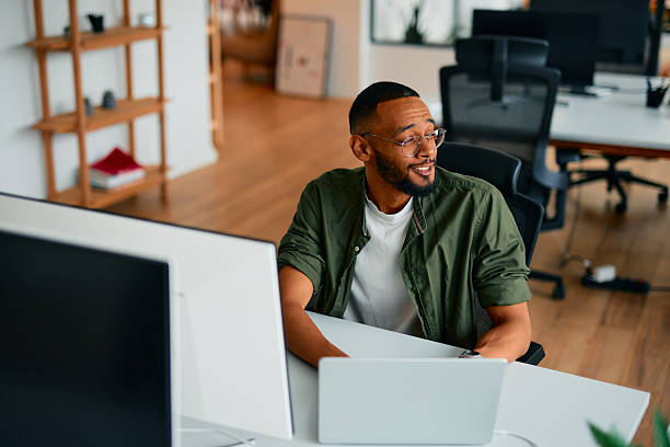 istock Young businessman working on laptop in modern office 2222964016