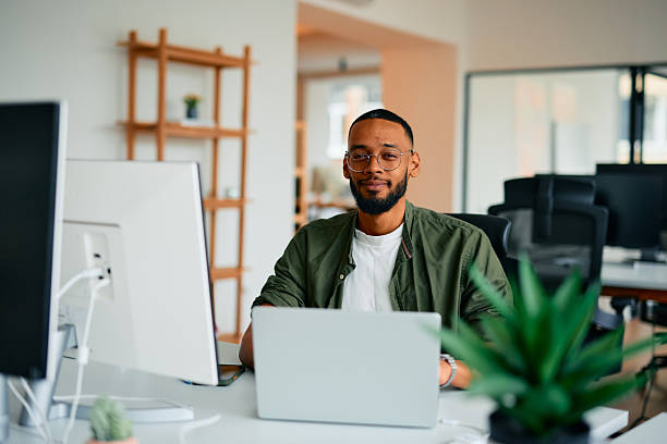 istock Confident young businessman working on laptop in modern office 2222964018
