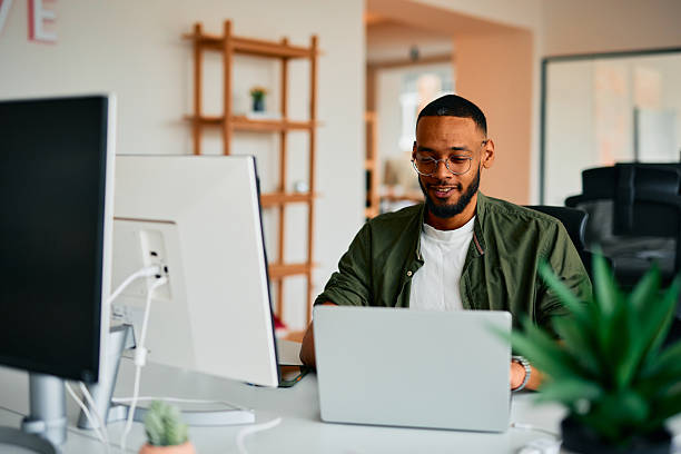 istock Young businessman working on laptop in modern office 2222964019