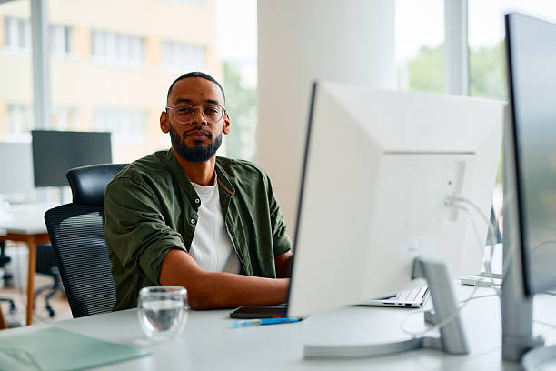 istock Confident young businessman working on computer in modern office 2222964024