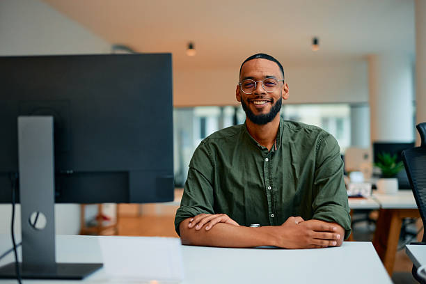 istock Confident young businessman smiling at the camera in the office 2222964112