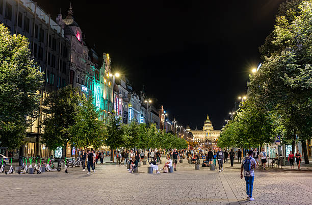 Prague, Czech Republic, August 4, 2023. Night shot with the impressive National Museum in the background. People walking on Wenceslas Square.