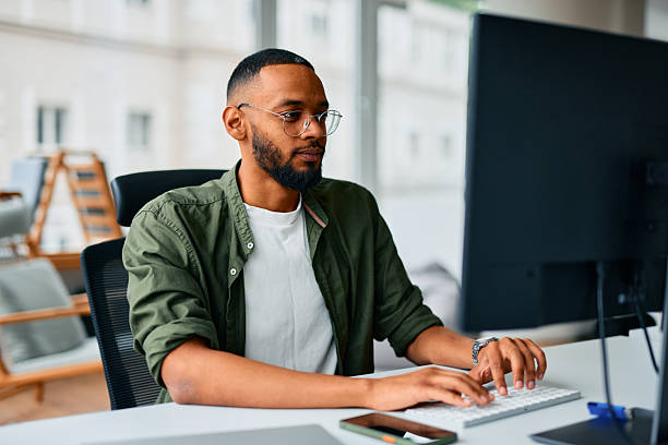 istock Focused young businessman typing on keyboard in modern office 2222964153