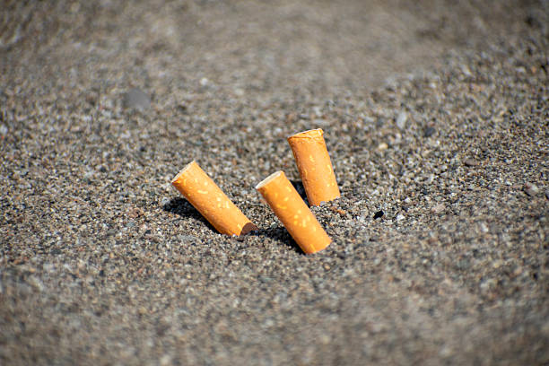 istock Cigarette butts thrown on the beach 2222964158