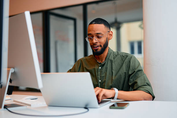istock Young businessman working on laptop in modern office 2222964170