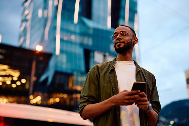 istock Young businessman using smartphone in city at dusk 2222964482