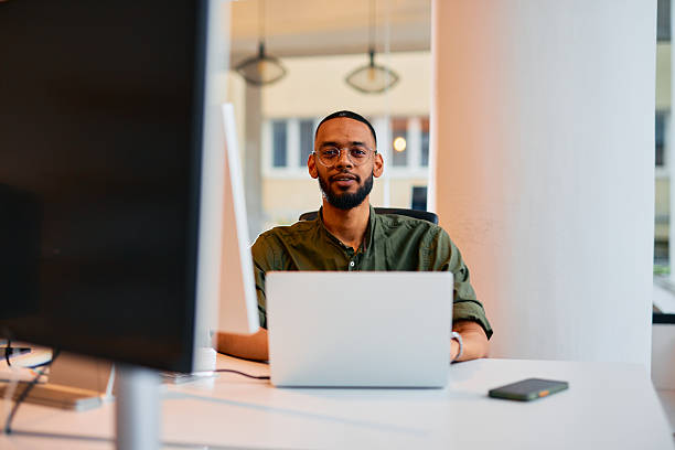 istock Confident young businessman working on laptop in modern office 2222964636