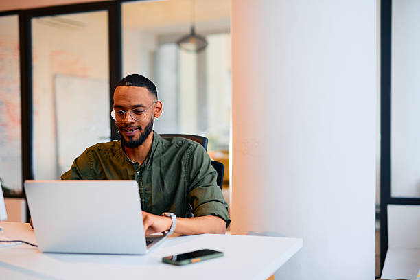 istock Young businessman working on laptop in modern office 2222964641