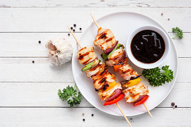 istock BBQ chicken kebabs with grilled vegetables on a white wood background 2222965451