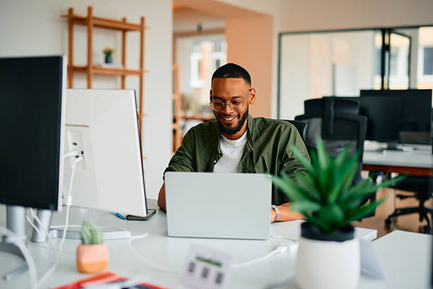 istock Young businessman working on laptop in modern office 2222965552