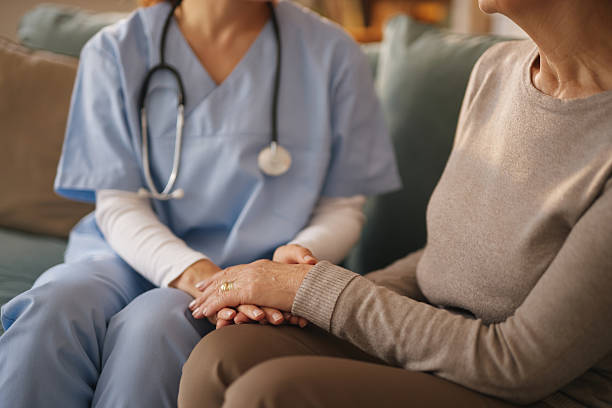istock Compassionate home nurse providing care to senior 2222969183