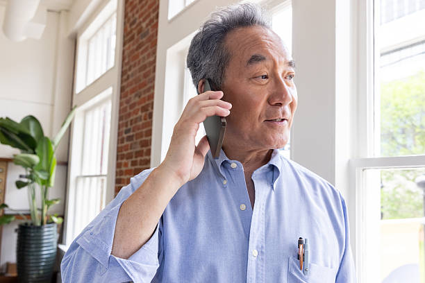 istock Senior entrepreneur takes phone call from client in modern office 2222969250