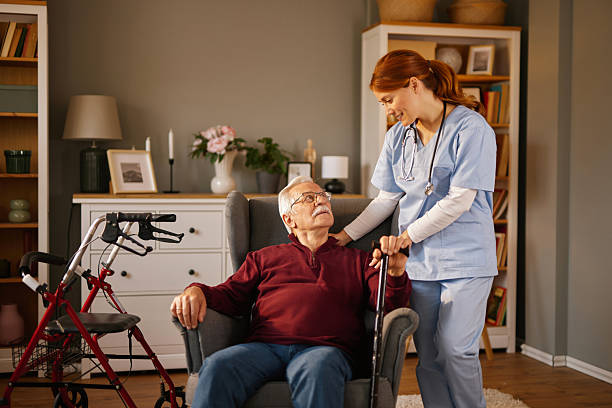 istock Nurse assisting senior man with walking cane at home 2222969934
