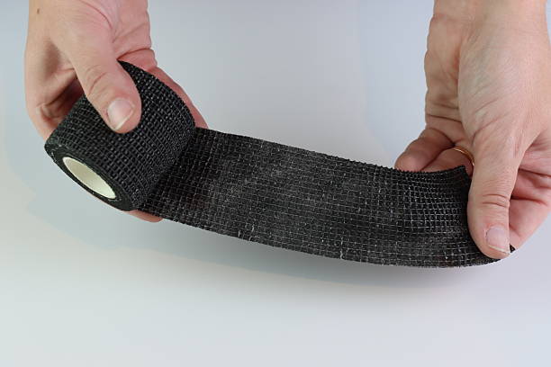 istock Black cohesive bandage beeing stretched 2222974124