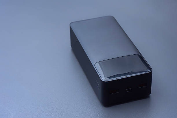 istock Large portable Power Bank in black color on a soft light background. Power source for charging smartphones and devices on the go. 2222976026