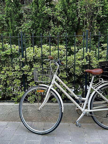 istock Parked white bike next to a fence 2222978476