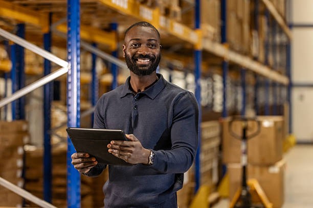 istock Warehouse Manager Smiling and Holding a Tablet in a Storage Facility 2222983034